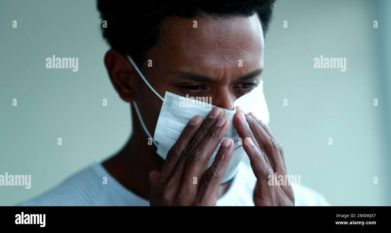 African man adjusting covid 19 hi-res stock photography and images - Alamy