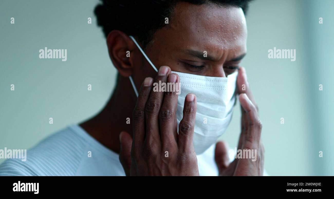 African man adjusting covid 19 hi-res stock photography and images - Alamy