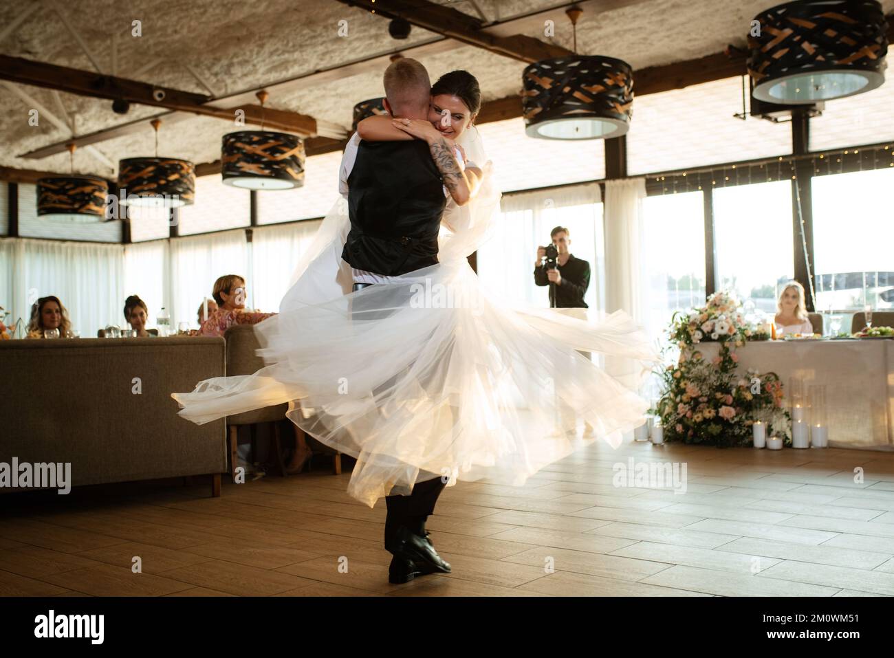 the first wedding dance of the bride and groom inside the restaurant