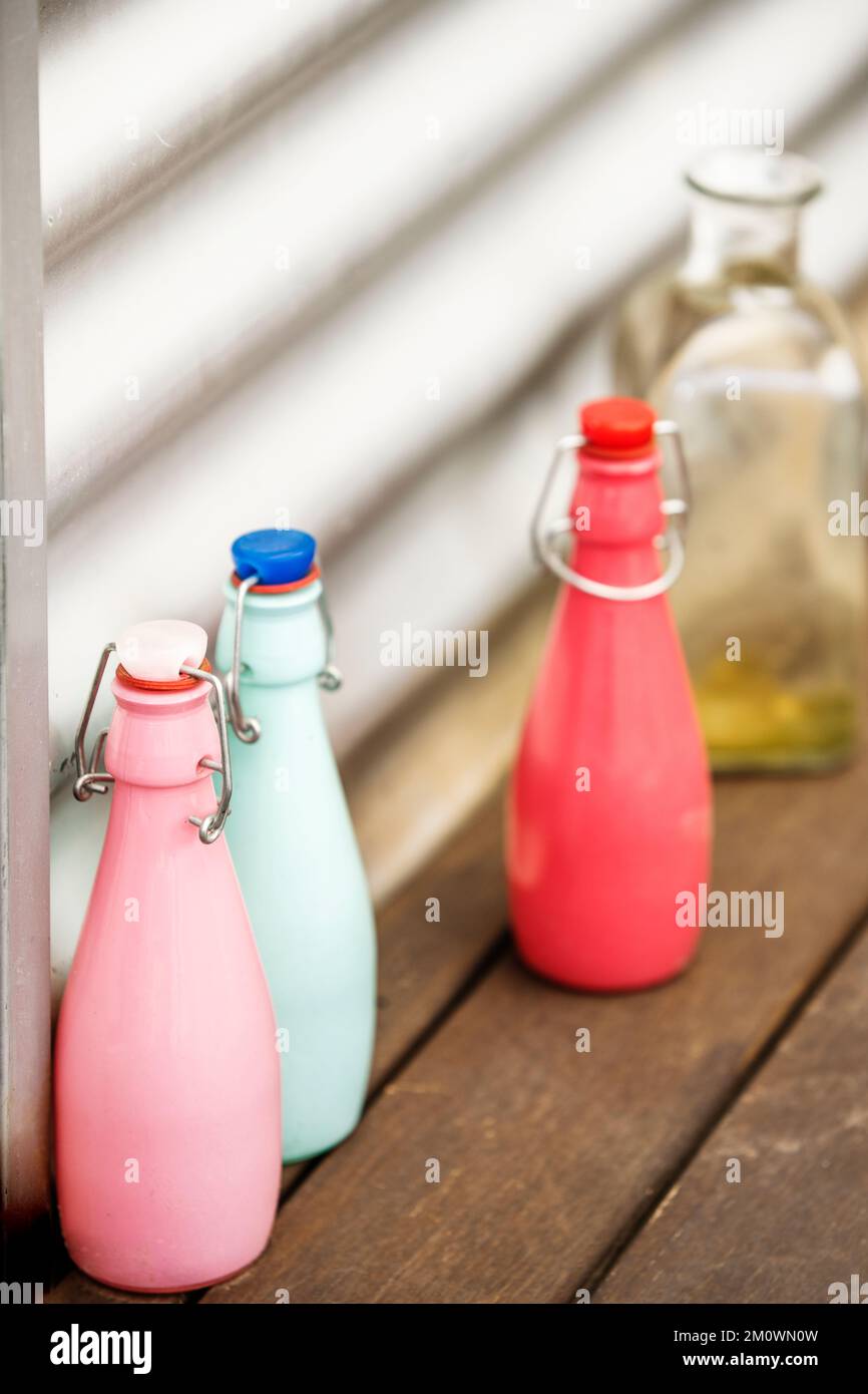 Decorative glass bottles of various colors with airtight stoppers Stock