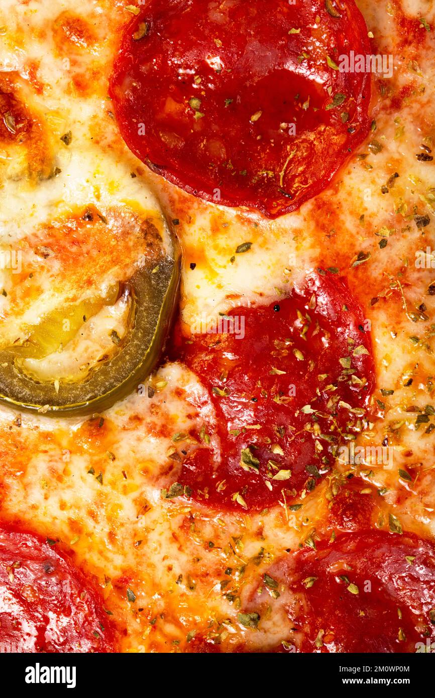 Salami pepperoni pizza texture with jalapeno as background. A close