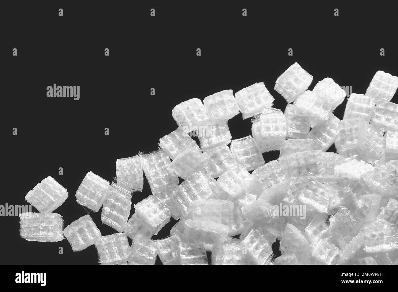 Close up picture of recycled plastic film chips, selective focus Stock