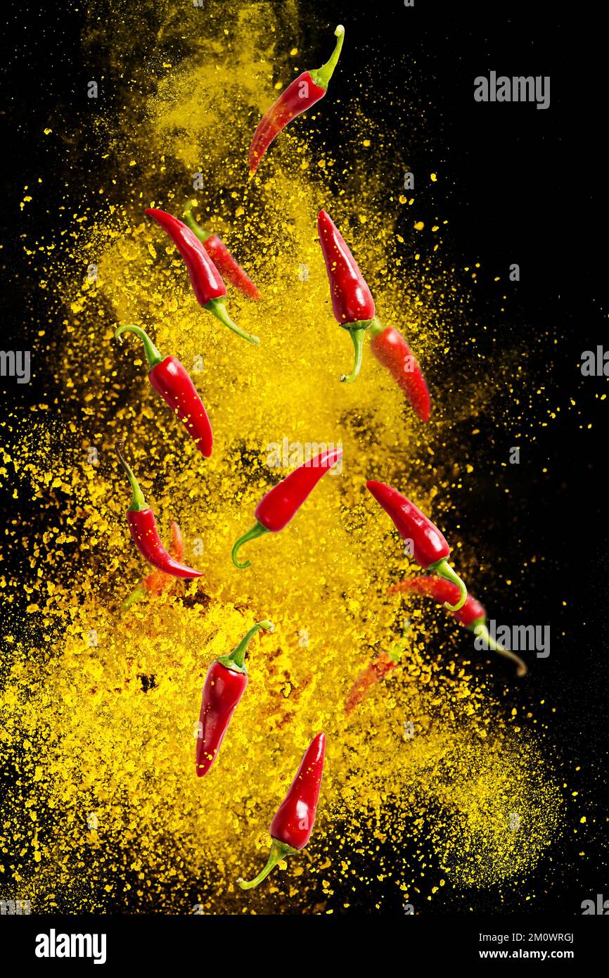 Fresh red chilli peppers floating in the air. food levitation. Falling red chilli pappers Stock