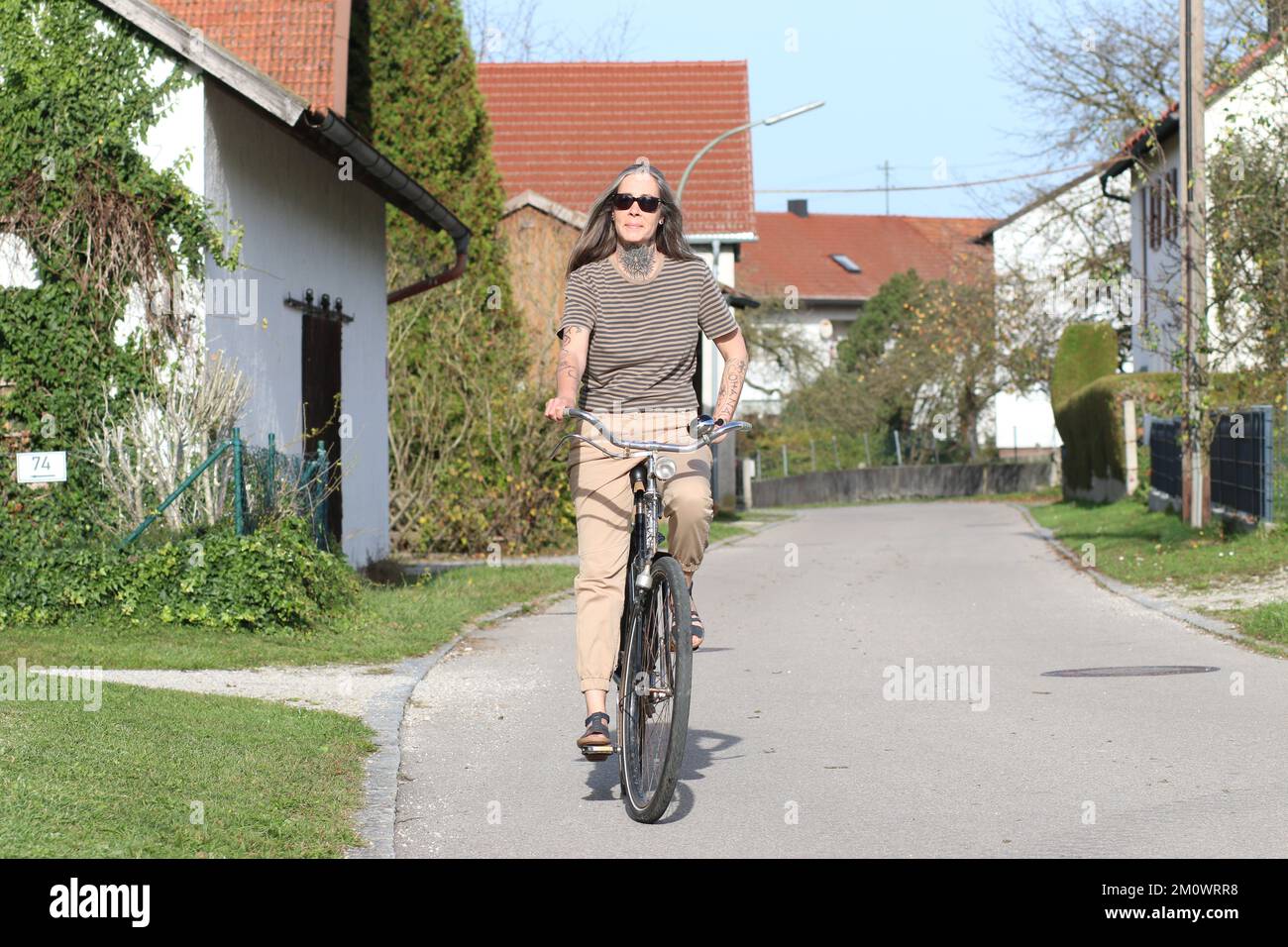 Best Ager Female Model 50 plus with Bicycle Ageing Better. Frau im besten Alter sitzt lässig auf einem Fahrrad und hält sich fit. 50 plus, Woman, acty Stock Photo