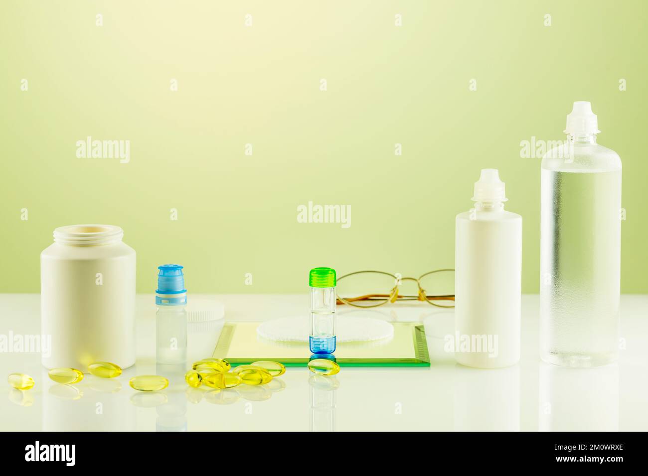 Oftalmology concept with containers with contact lenses, eye drops