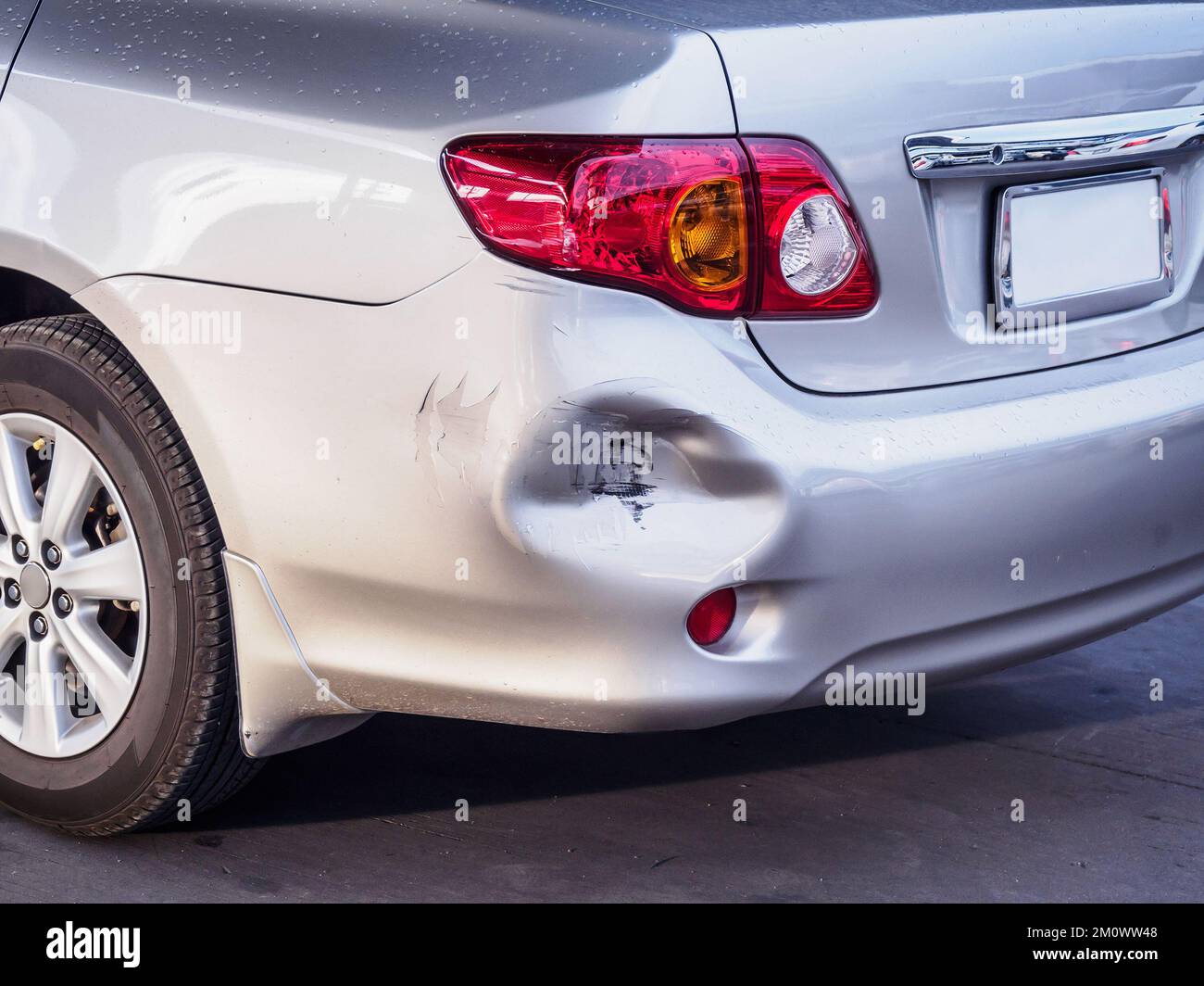 car has dented rear bumper damaged after accident Stock Photo