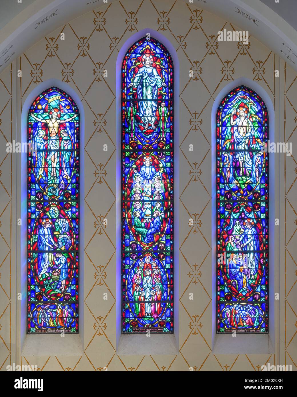 Three stained glass windows above the altar at the historic Cathedral of St. John in downtown Albuquerque, New Mexico Stock Photo