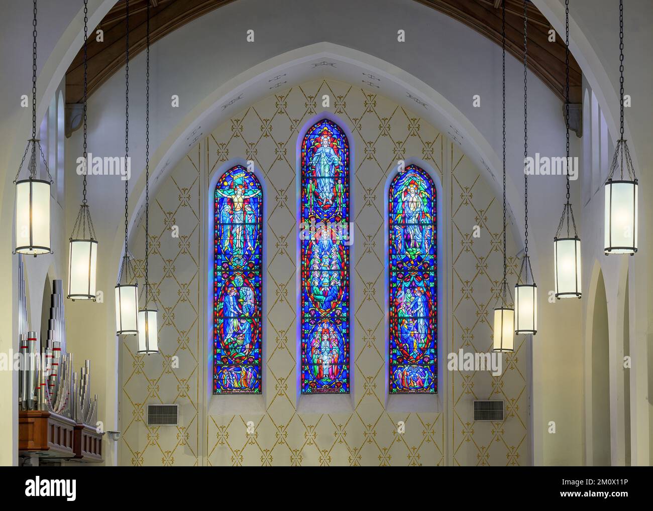 Three stained glass windows above the altar at the historic Cathedral of St. John in downtown Albuquerque, New Mexico Stock Photo