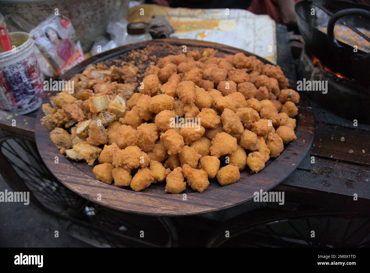 Deep fried lentil fritters or Indian Pakora on display at street side
