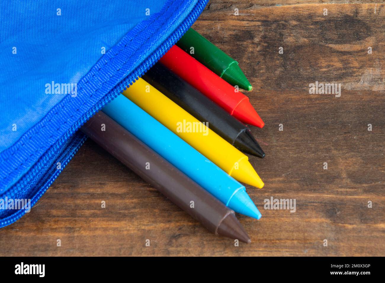 crayon pencil sticking out of a school case representing back to school
