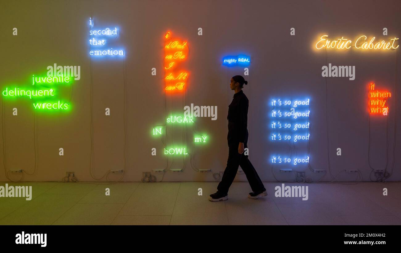 london-uk-8-december-2022-a-staff-member-passes-exhibits-at-a
