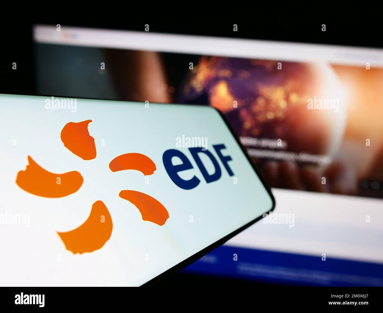 Smartphone with logo of energy company Electricite de France S.A. (EDF) on screen in front of website. Focus on center-left of phone display. Stock Photo