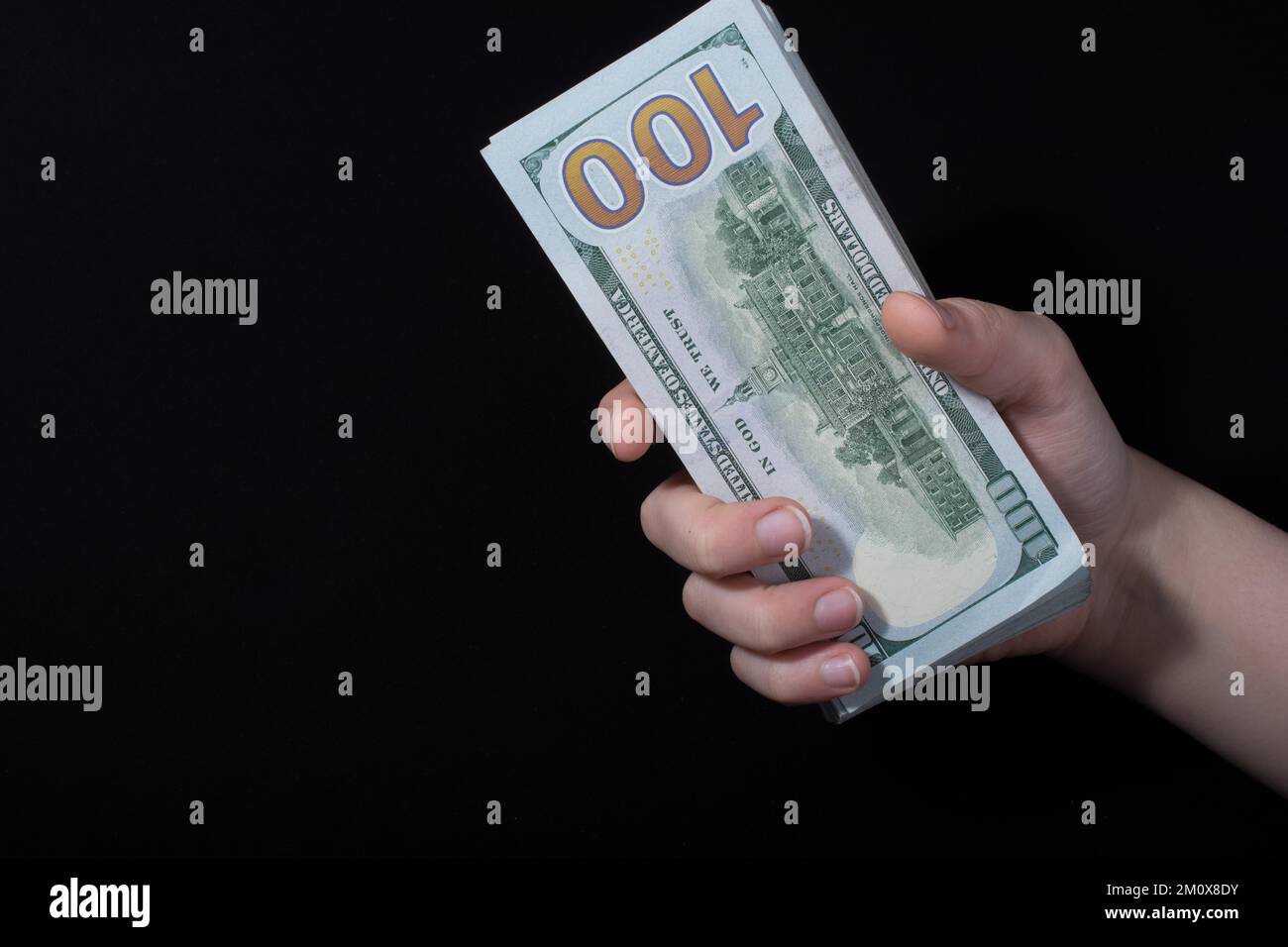 Hand holding American dollar banknotes isolated on white background ...