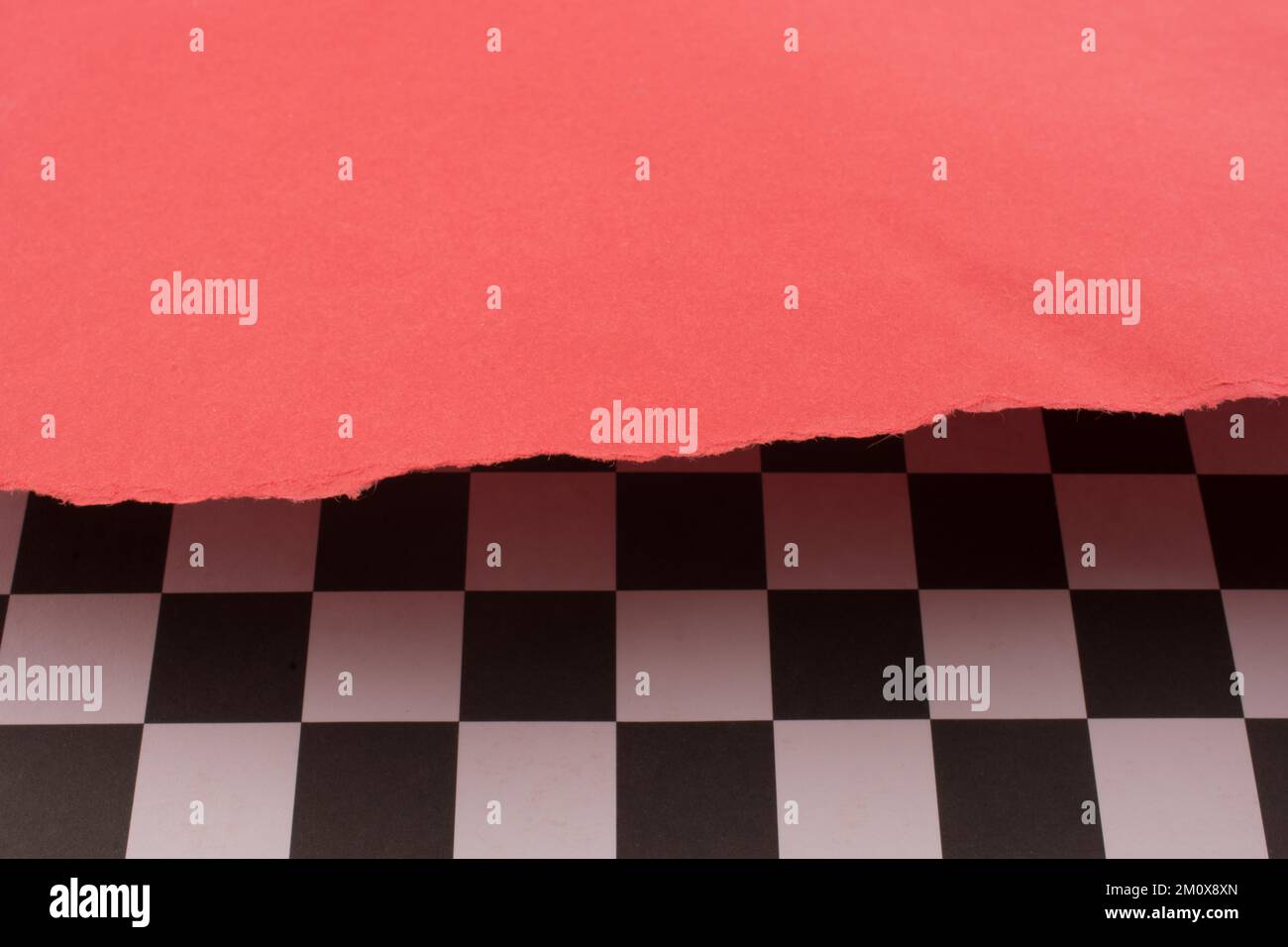 Red paper and black and white checked board pattern Stock Photo - Alamy