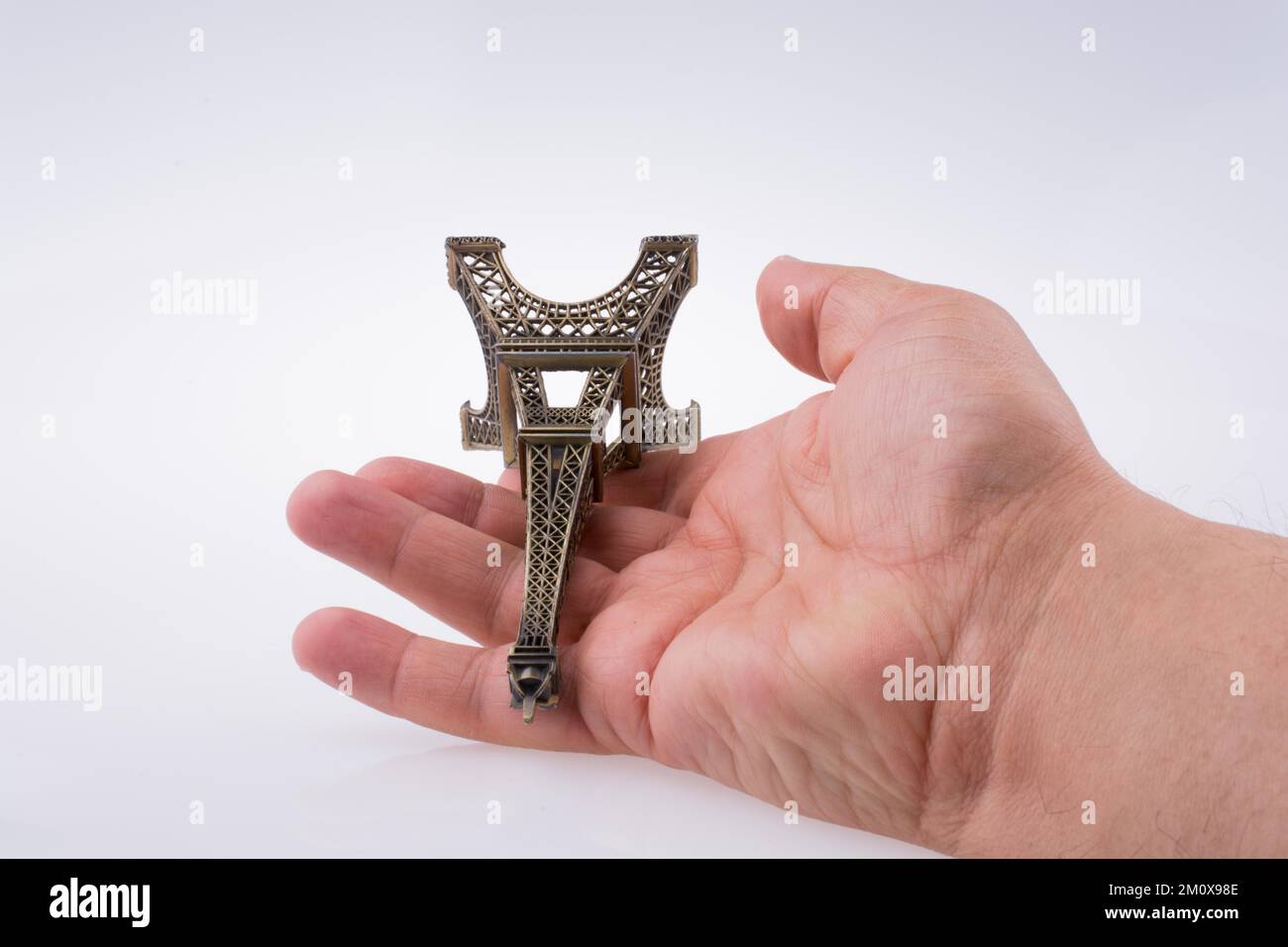 Hand holding the Eiffel tower on a white background Stock Photo - Alamy