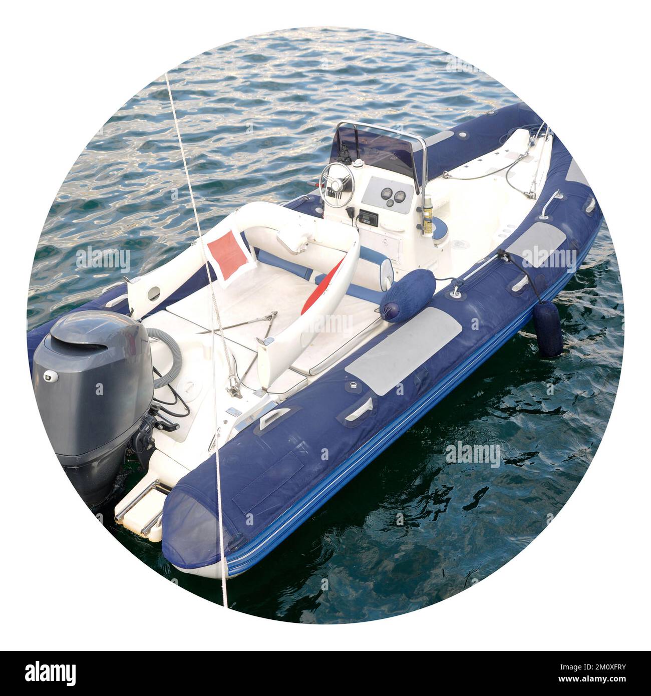 Modern inflatable boat with engine in the sea near shore, blue white