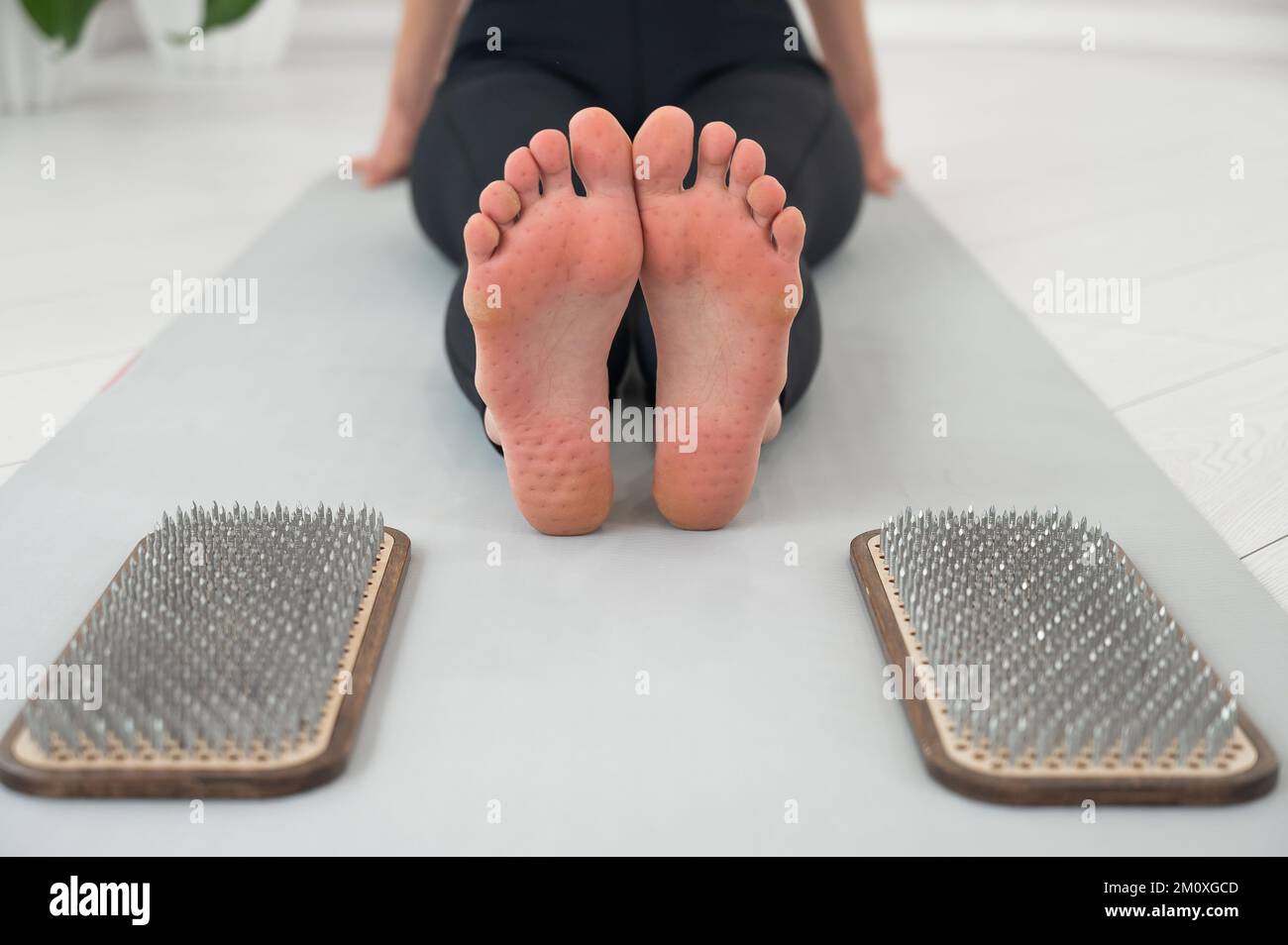 Closeup on the feet of a woman after standing on the nails of a sadhu