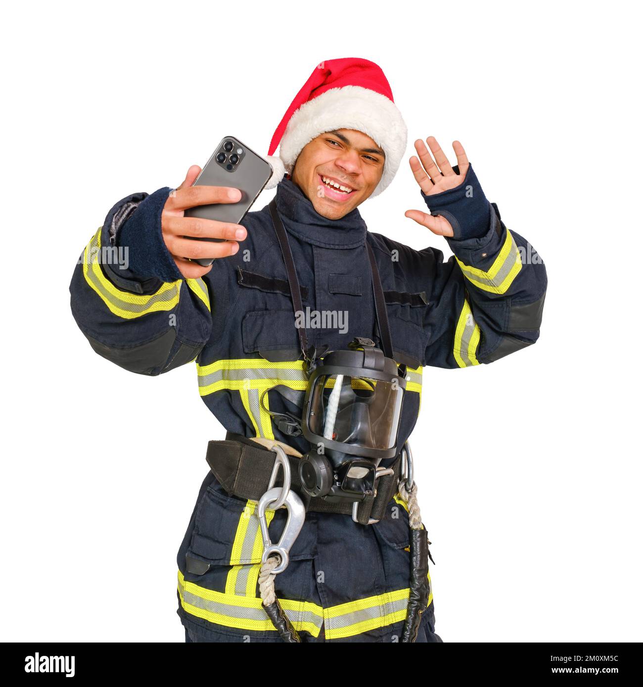 Fireman in Santa Hat takes a selfie Stock Photo