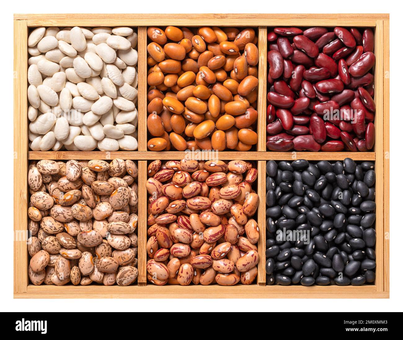 Variety of dried common beans, pulse assortment in a wooden box. White navy, Dutch brown, kidney, pinto, cranberry and black turtle beans. Stock Photo