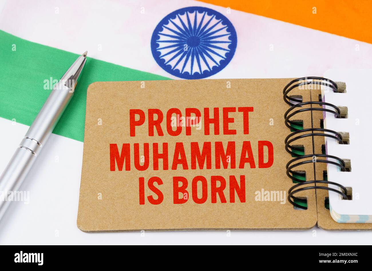 Holidays in India. Against the background of the flag of India lies cardboard with the inscription - Prophet Muhammad is born Stock Photo