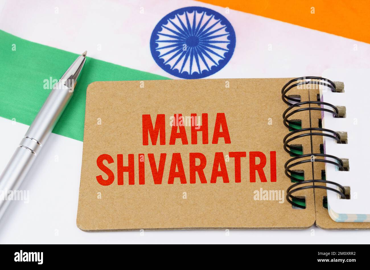 Holidays in India. Against the background of the flag of India lies cardboard with the inscription - Maha Shivaratri Stock Photo