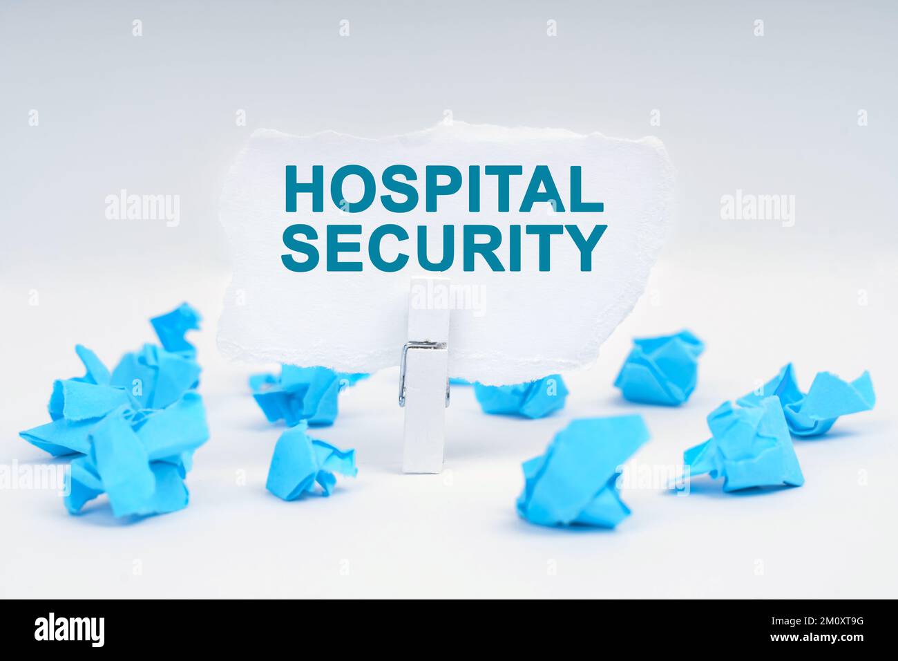 Medicine and health concept. On a white background, there are blue pieces of paper and a clothespin with paper on which it is written - HOSPITAL SECUR Stock Photo