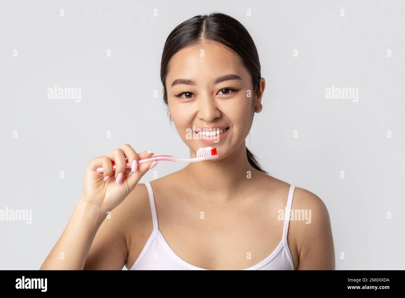 woman with beautiful smile with white teeth holding toothbrush with