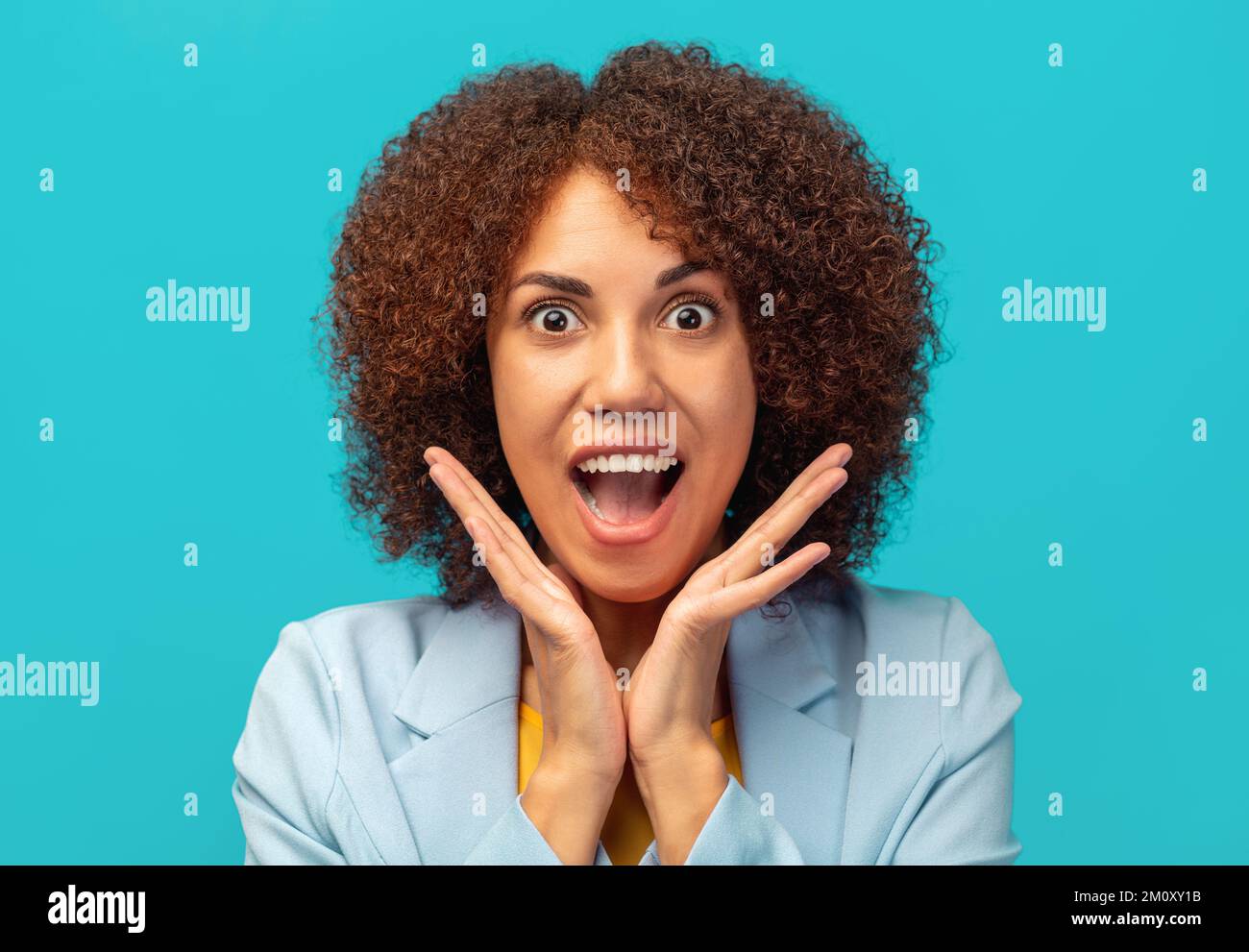 Good news, sale, shopping or big discounts concept. African American woman with curly hair screaming wow Stock Photo