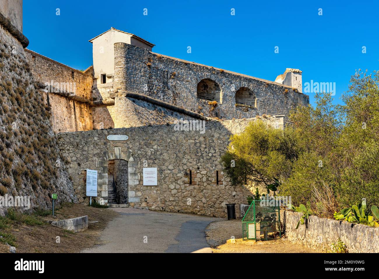 Antibes, France - August 4, 2022: Defense walls and towers of medieval fortress Fort Carre castle in Antibes resort city onshore Azure Cost Stock Photo