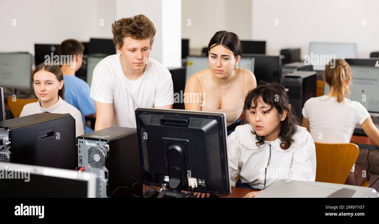 Teenagers using computer during computer science lesson Stock Photo