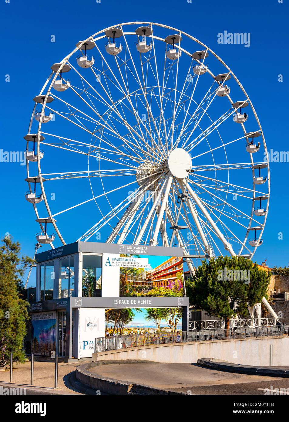 Antibes, France - August 4, 2022: Grand Ferris Wheel Grande Roue at Esplanade du Pre des Pecheurs promenade in Vauban Port and yacht marina Stock Photo