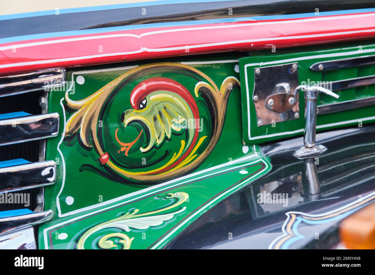 Buenos Aires, Argentina, June 20, 2022: Decorative detail on the bodywork of a 1942 Chevrolet bus of the line 45. Dragon painted in the fileteado port Stock Photo
