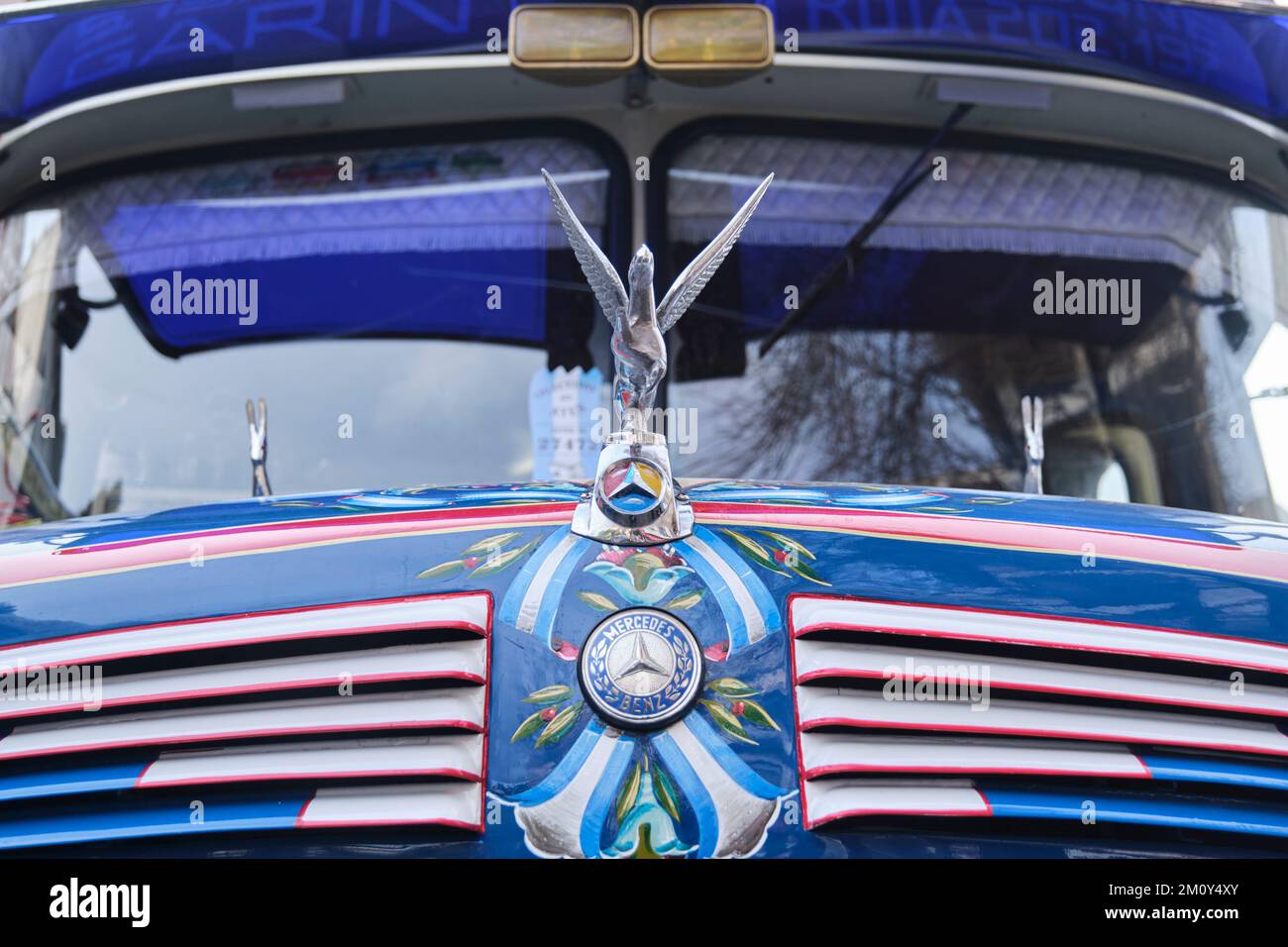 Buenos Aires, Argentina, June 20, 2022: frontal close up view of a Mercedes Benz 911, old vintage bus for public transport: Pegasus hood ornament, log Stock Photo