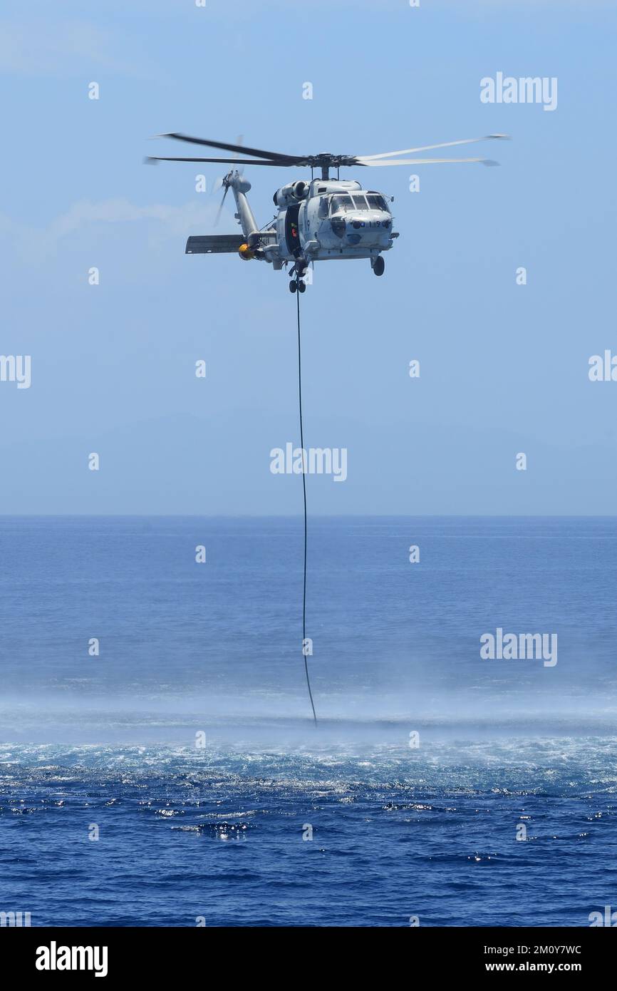 A patrol helicopter of the Japan Maritime Self-Defense Force hovering over the sea. Stock Photo