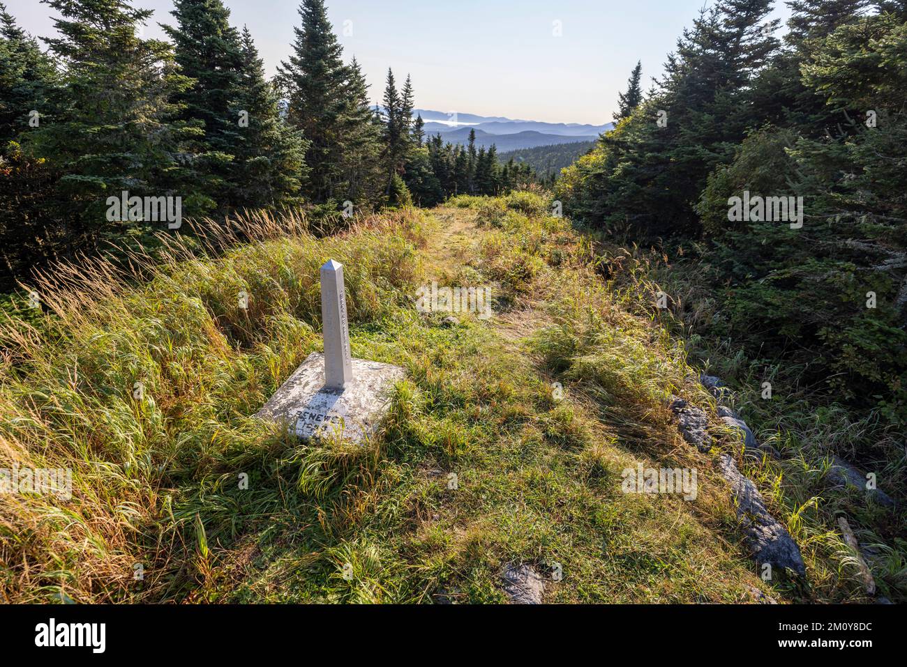 stone marker indicates international boundary between USA Canada Stock Photo