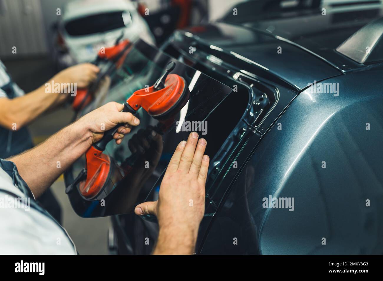 Automobile repair process. Closeup indoor portrait of two