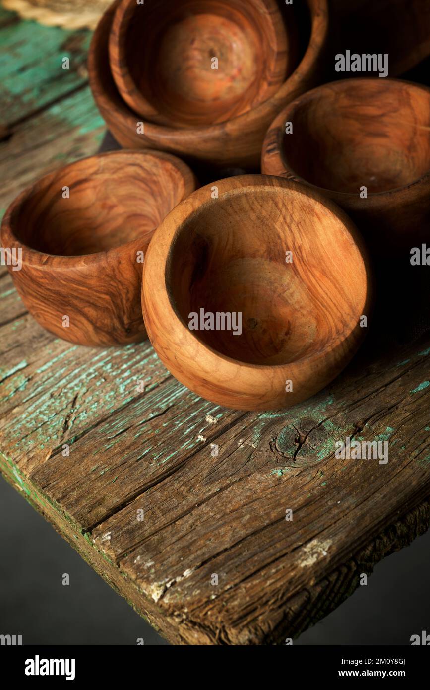 Olive wood bowls on a green table. Stock Photo