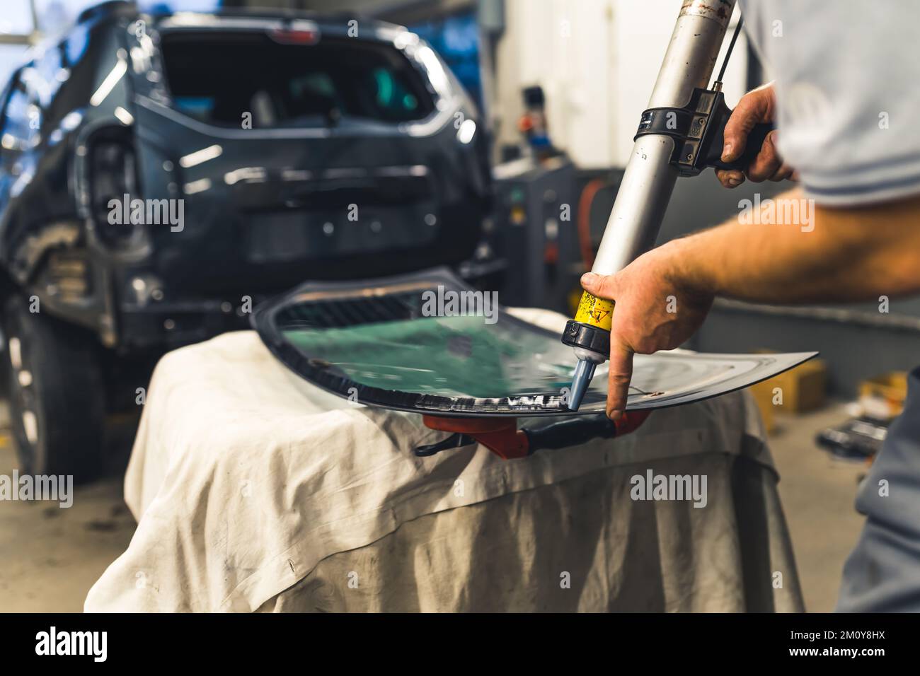 Installing process of car window. Indoor shot of professional