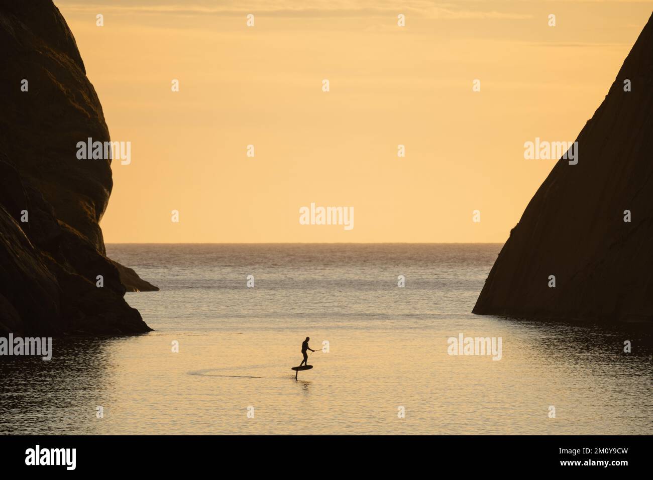 E-foil rider riding in fjord, Nusfjord, Lofoten Islands, Norway Stock ...