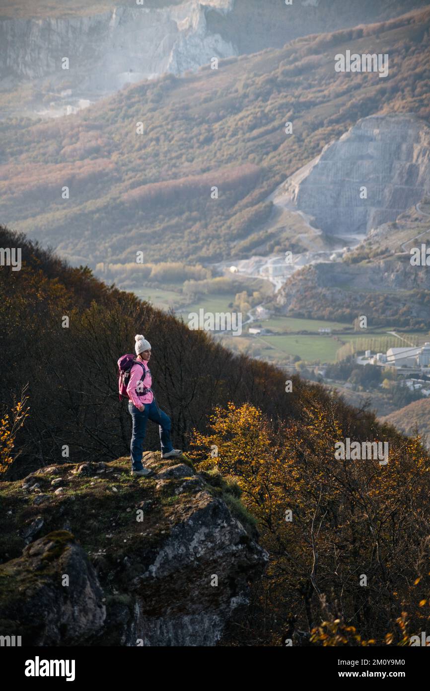 Female mountaineer on top of the precipice. Stock Photo