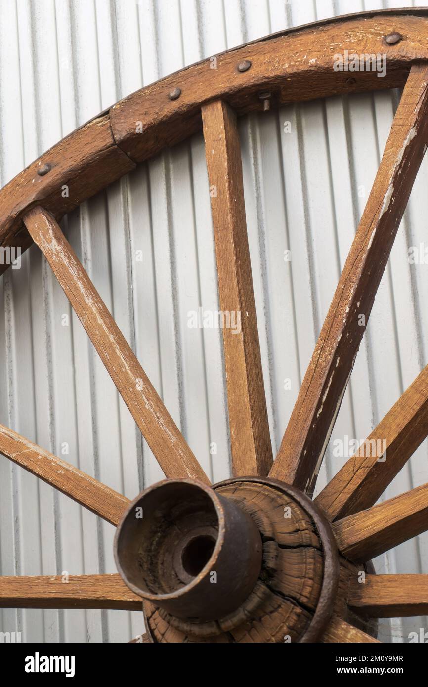 Antique wooden wheel on metallic background Stock Photo