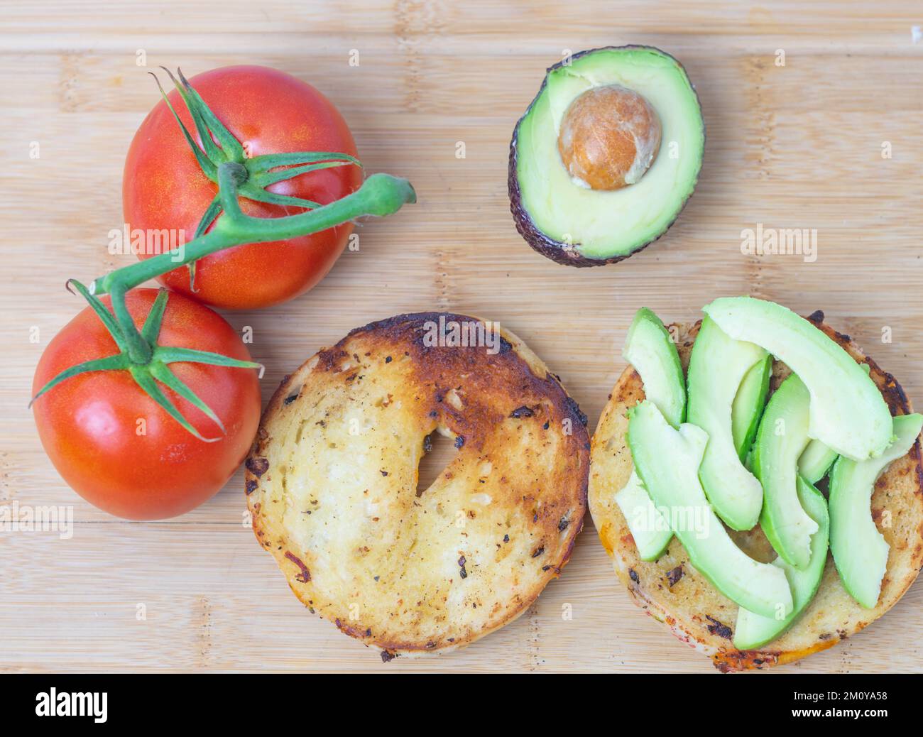 Top down toasted bagel sandwich with egg and vegetables Stock Photo