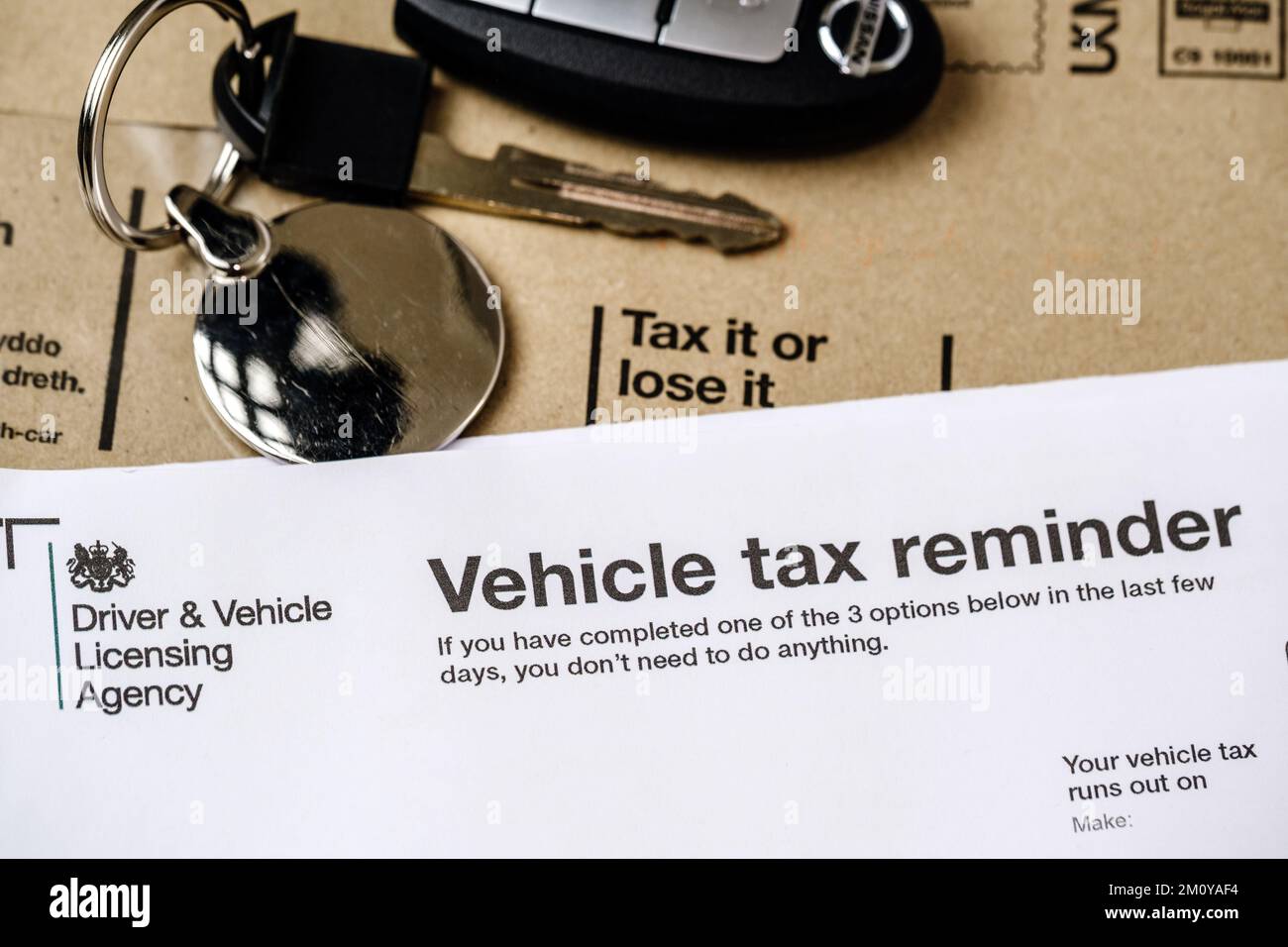 Authentic V11 Vehicle tax reminder letter from DVLA placed on brown envelope. UK road tax for your car. Stafford, United Kingdom, December 8, 2022 Stock Photo