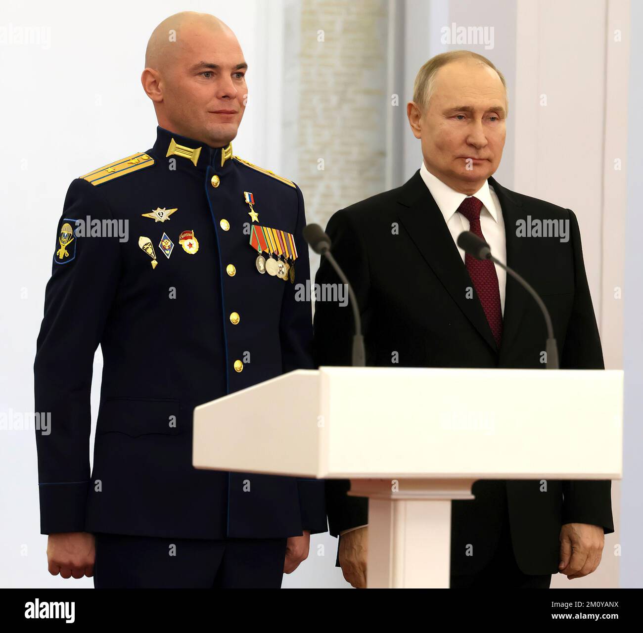 Russian President Vladimir Putin at the ceremony to present Gold Star medals to Heroes of Russia.  With Major Boris Dudko, Deputy Commander of the 124th Separate Tank Battalion of the 76th Guards Airborne Assault Division.Photo: The Russian President's Office Stock Photo
