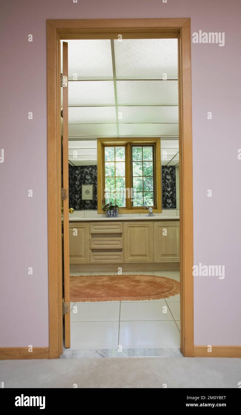 Bathroom vanity through doorway inside mixed decorated and