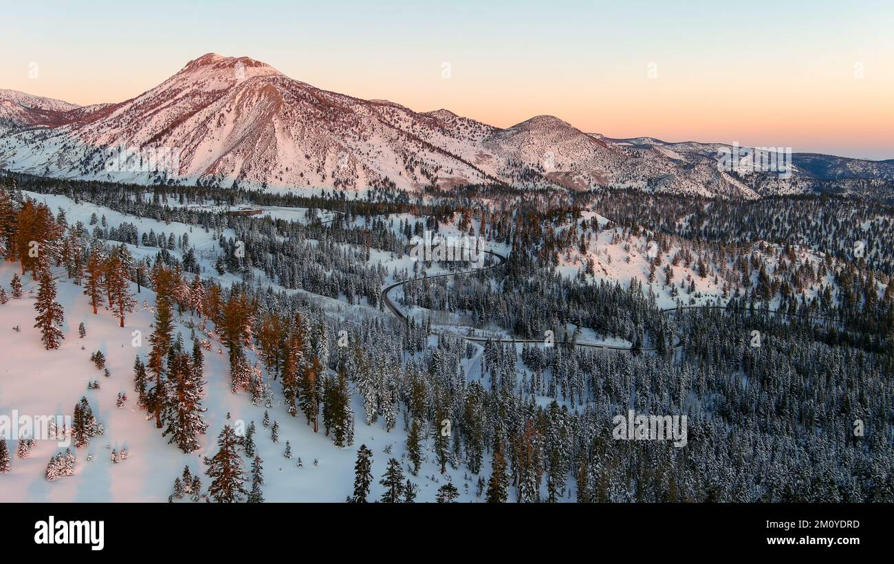 Aerial view of a winding road in the snowcapped mountains near Reno Nevada at sunrise Stock Photo