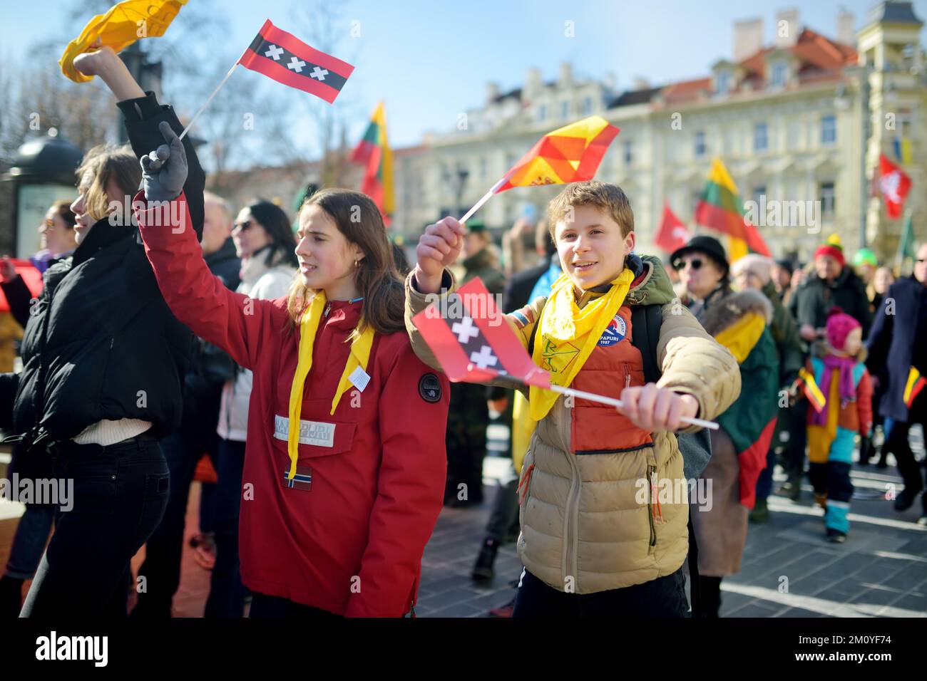 VILNIUS, LITHUANIA - MARCH 11, 2022: Cheerful people carrying tricolor Lithuanian flags on a festive events as Lithuania marked the 32th anniversary o Stock Photo
