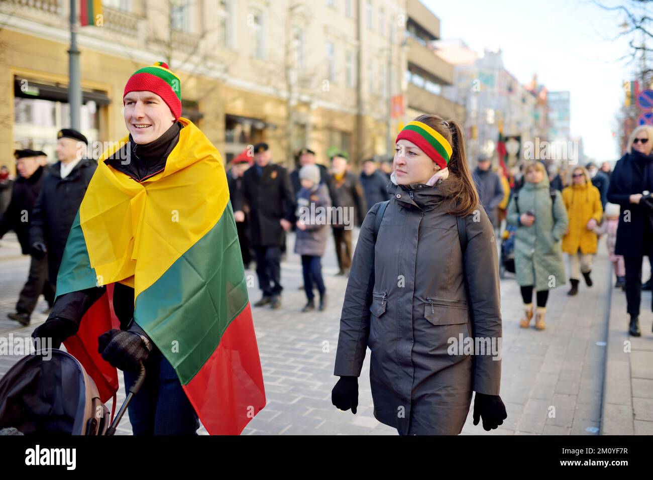 VILNIUS, LITHUANIA - MARCH 11, 2022: Cheerful people carrying tricolor Lithuanian flags on a festive events as Lithuania marked the 32th anniversary o Stock Photo