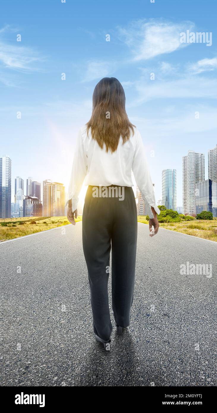 Rear view of an Asian businesswoman walking on the street Stock Photo ...