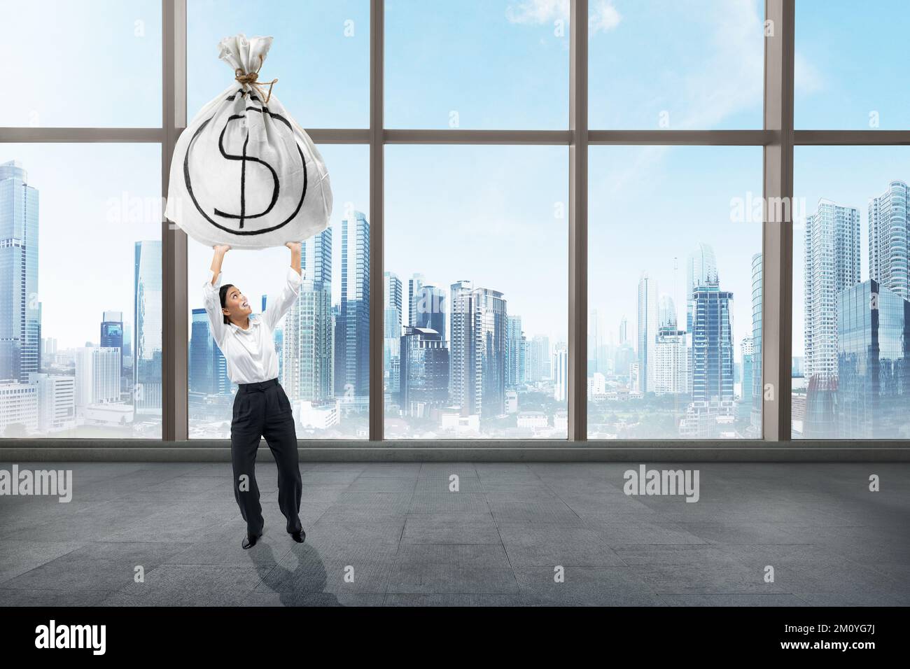 Asian businesswoman standing while holding dollar money bag in the ...